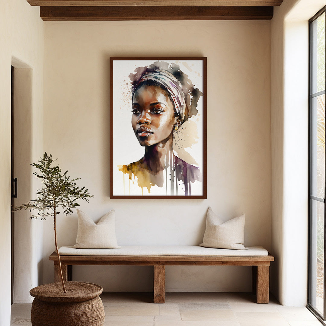 A large framed 'Aisha Rising' fine art print hanging in a sophisticated, neutral-toned entryway. The watercolor portrait brings color, depth, and modern elegance to the minimalist interior.